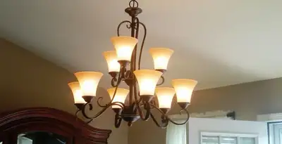 Classic ceiling chandelier installation with warm lighting in Madison, WI