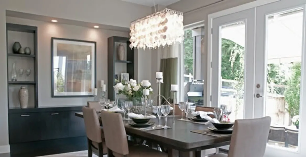 Elegant dining room chandelier installation above table in Madison, WI