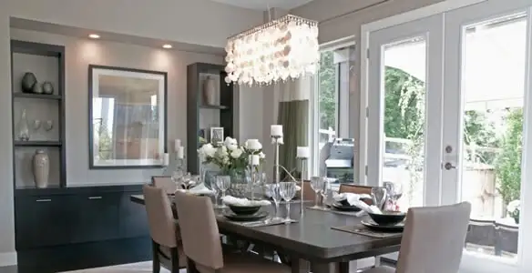 Elegant dining room chandelier installation above table in Madison, WI