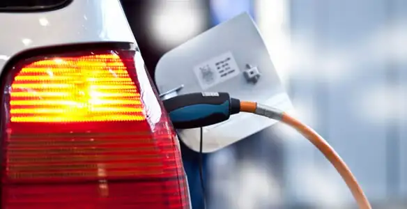 Electric car plugged into EV charger after professional installation in Madison, WI