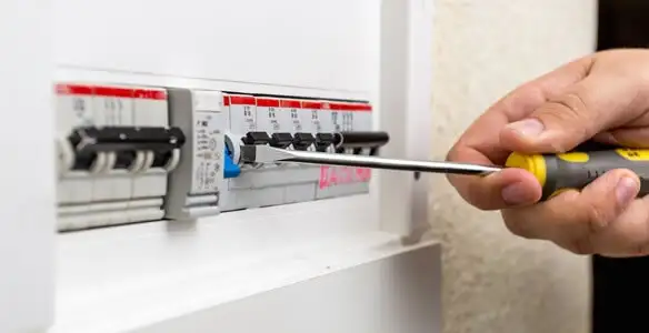 electrical panel upgrade service showing technician adjusting circuit breakers during system upgrade in Madison, WI