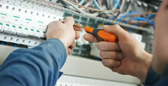electrical service showing licensed electrician performing electrical panel maintenance and adjustments in Madison, WI