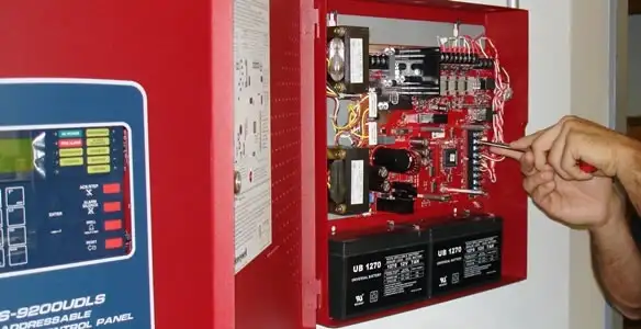 fire alarm installation service showing technician configuring fire alarm control panel in Madison, WI