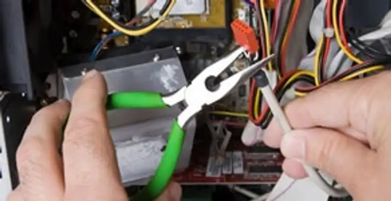 Licensed electrical contractor performing electrical repair with tools in Oregon, WI