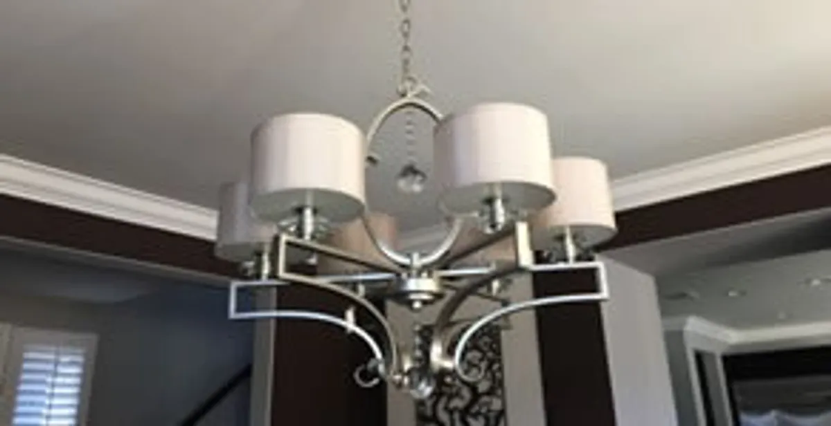 Modern chandelier installation with multiple light fixtures in Madison, WI