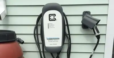 Outdoor electric vehicle charger installation on residential wall in Madison, WI