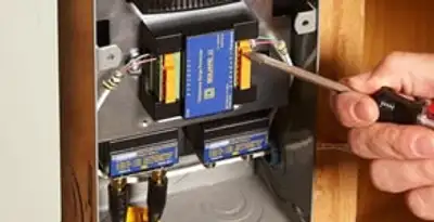 Whole home surge protection device being installed by a licensed electrician to protect electrical systems in Madison, WI